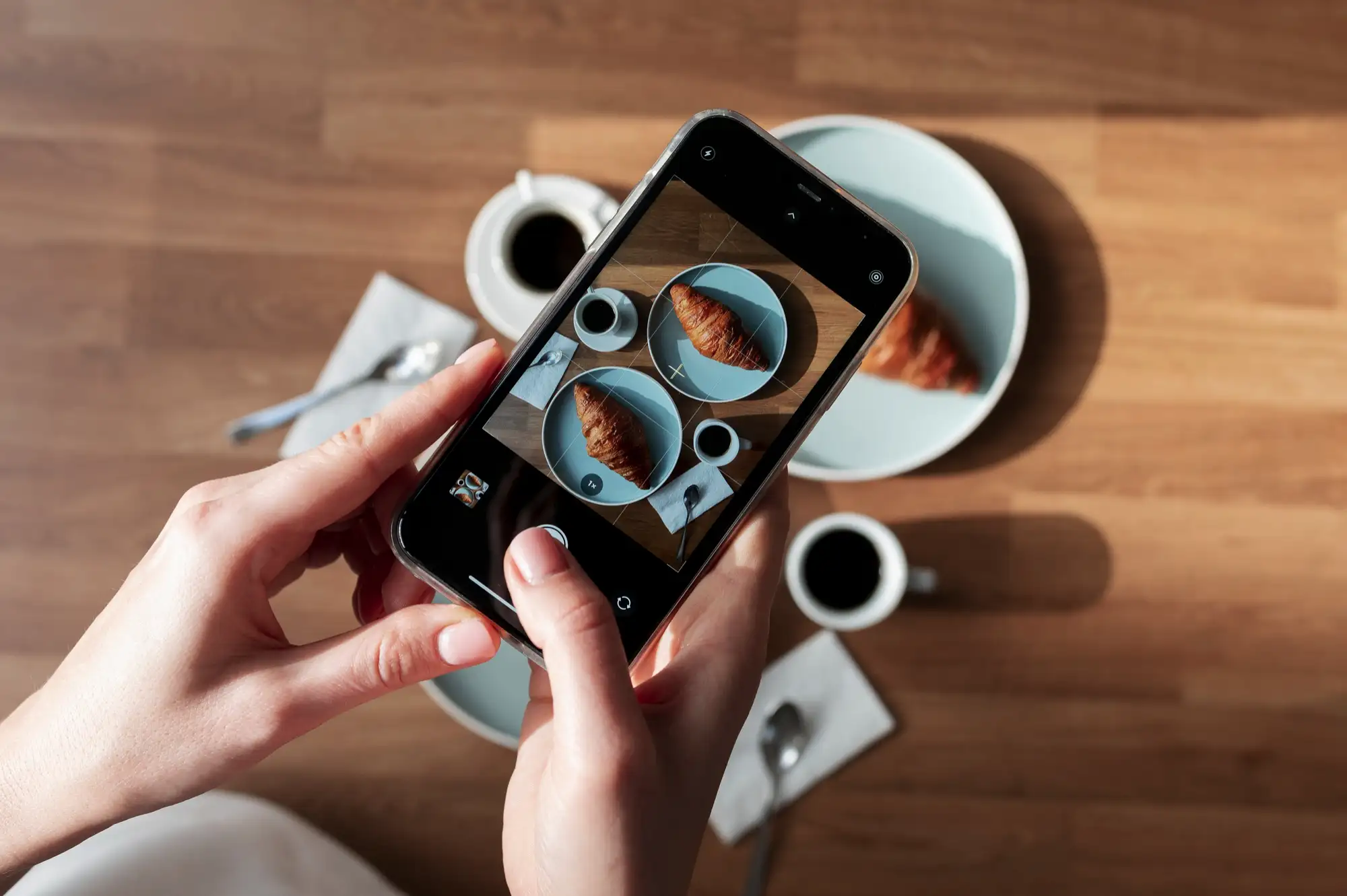 woman-taking-photo-two-croissants